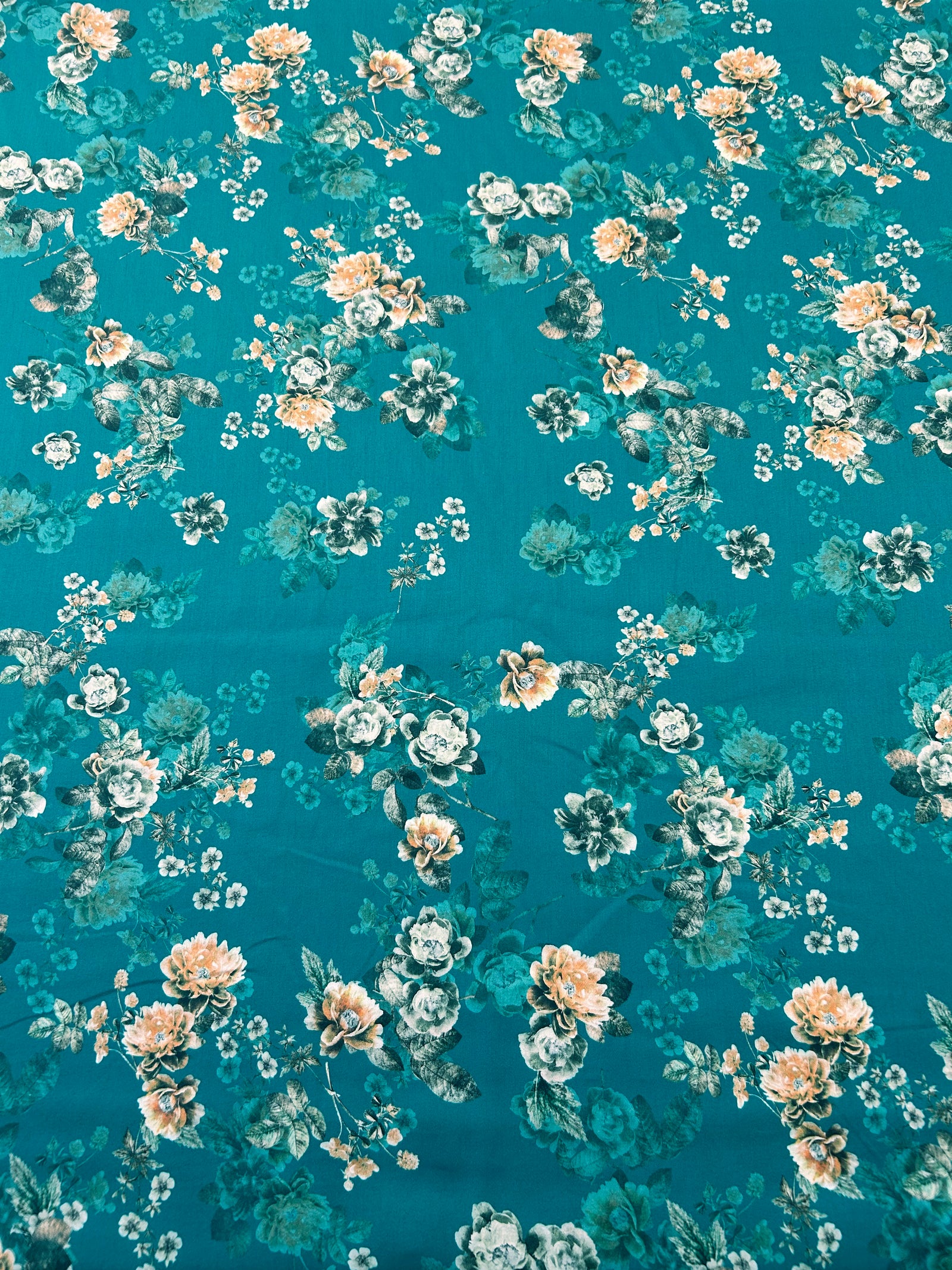 Cotton fabric with a Peach Floral pattern on a teal background.