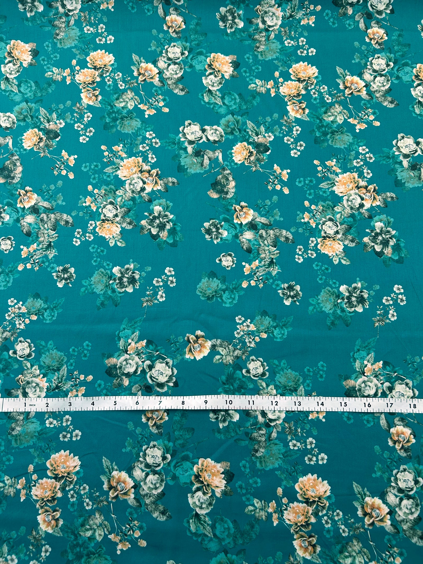 Cotton fabric with a Peach Floral pattern on a teal background.