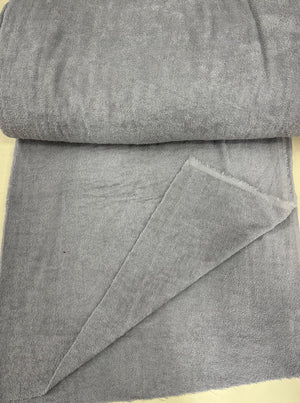 Roll of gray terryfabric on a beige surface