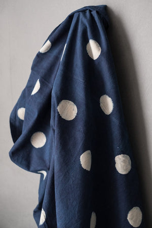 Indian cotton fabric in dark Indigo with white block printed circles. 