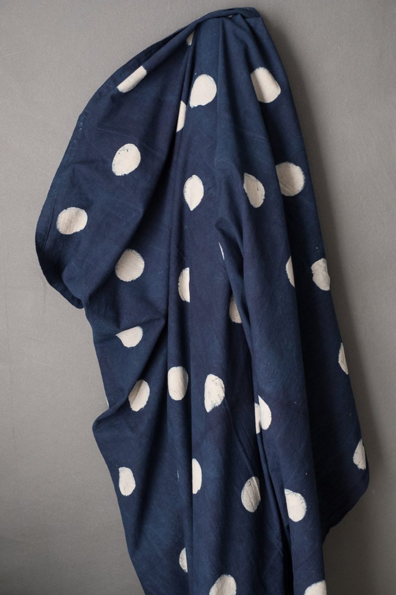 Indian cotton fabric in dark Indigo with white block printed circles. 