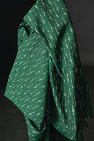 A stunning chequered Ikat weave with ochre and white dashes on a background of dark emerald green.
