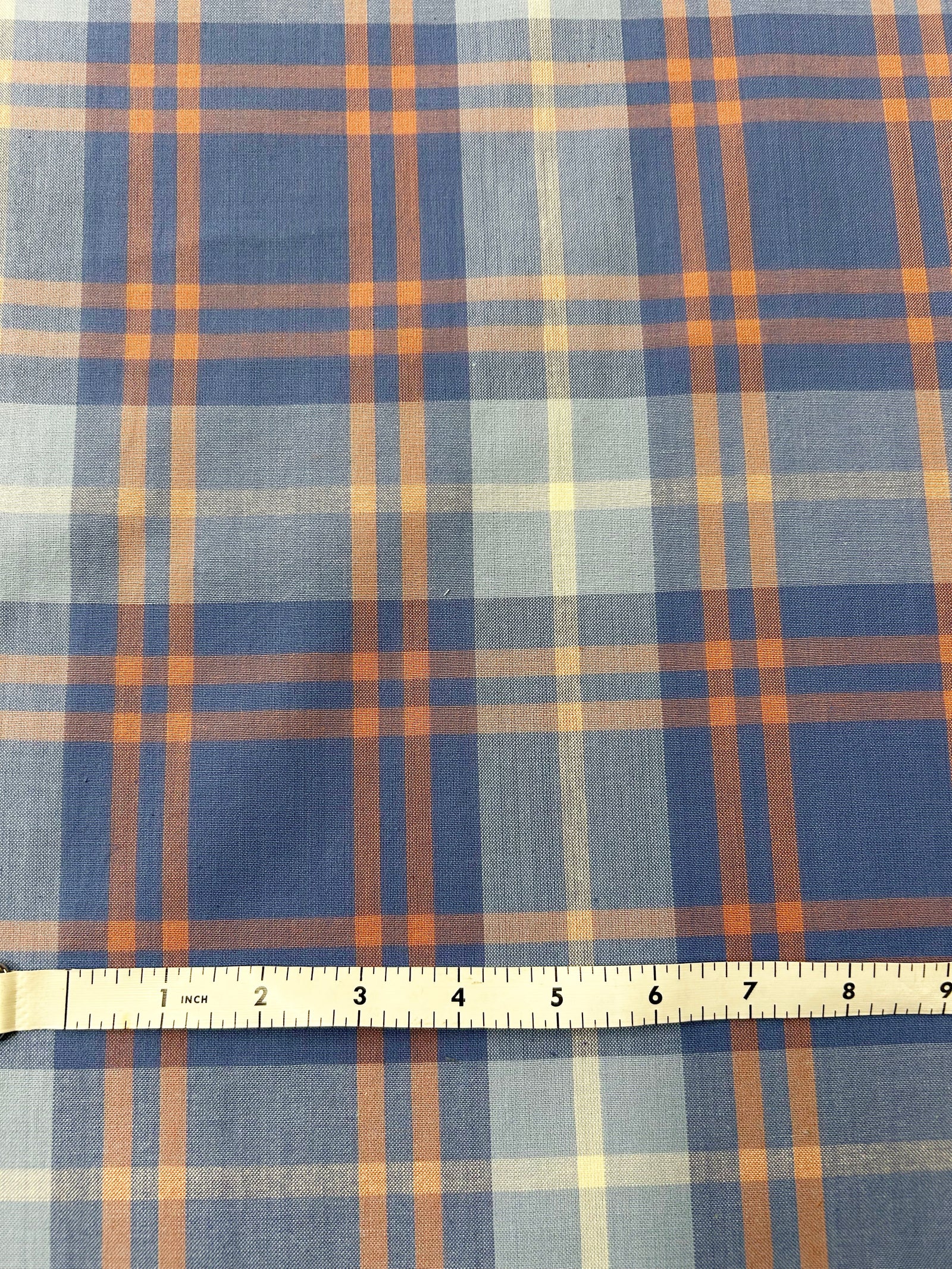 100% plaid cotton fabric with spring dreamy colors of peaches, blues and periwinkle.