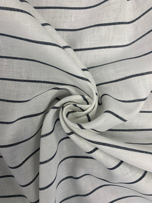 White linen cotton fabric with black stripes in a spiral in one inch increments horizontally