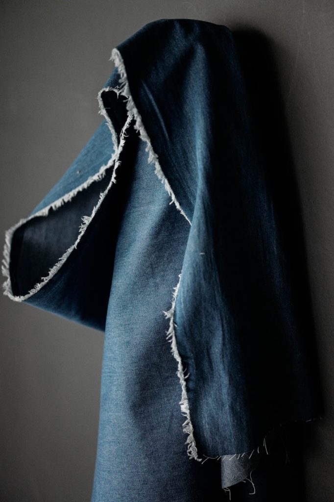 Medium Washed Cotton Denim fabric on a dark grey background