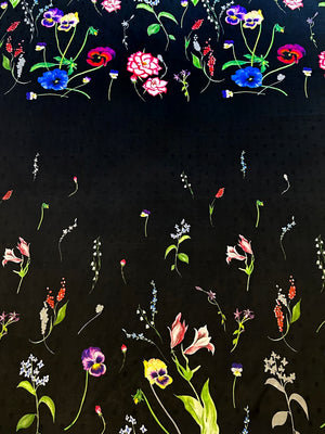 Floral pattern with pink roses and colorful flowers on a black polka dot background.