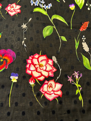 Floral pattern with pink roses and colorful flowers on a black polka dot background