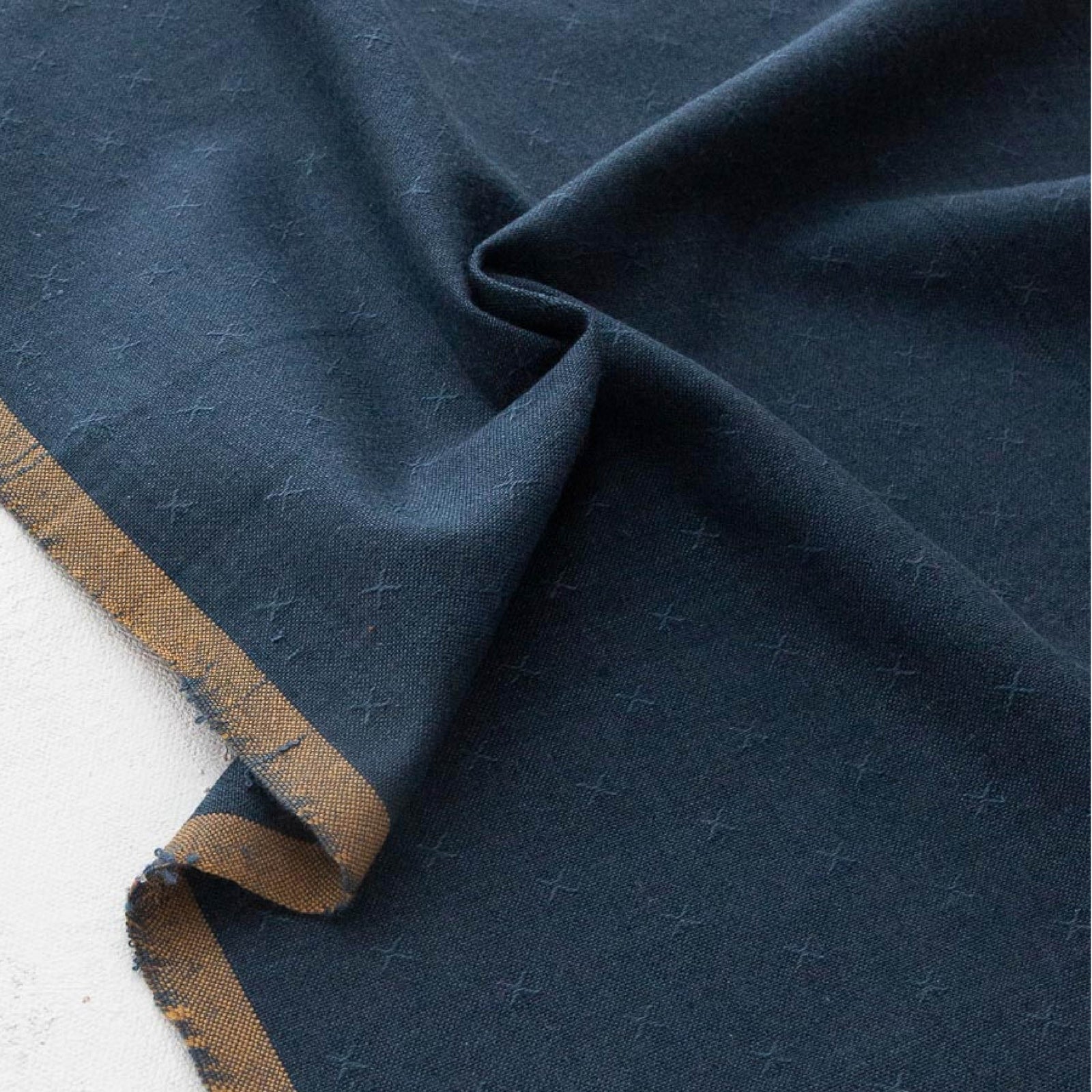 Navy fabric with a brown border on a white background