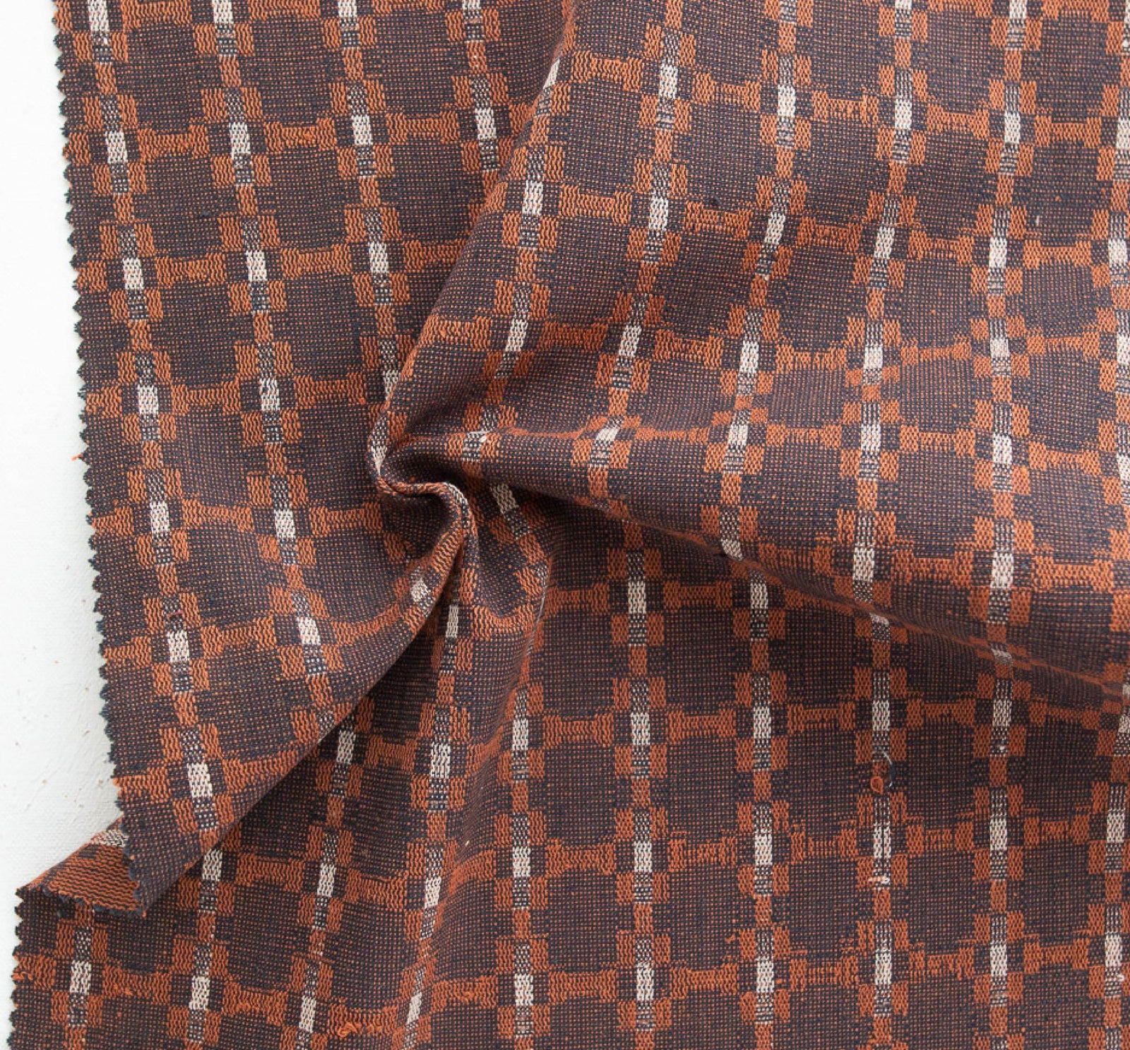brown, ocher, and white fabric woven in a design