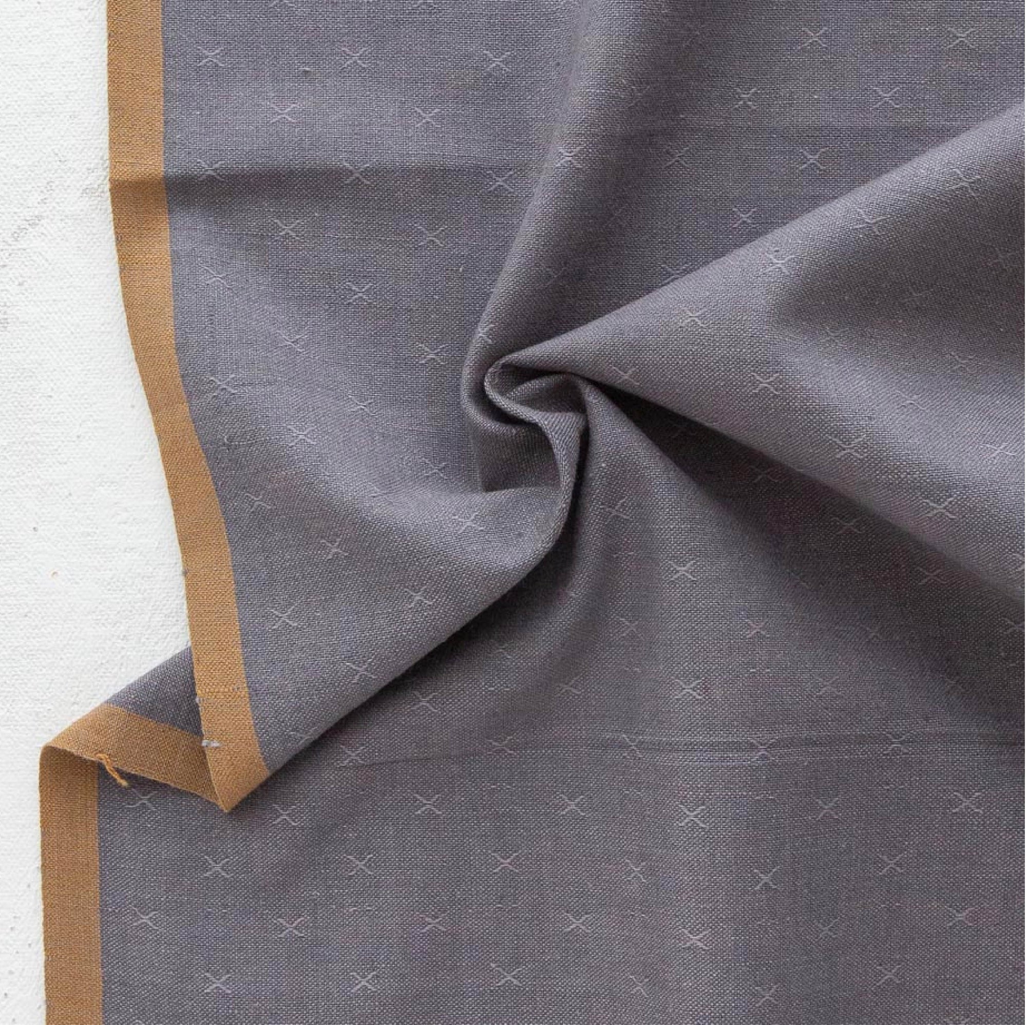Gray fabric with a subtle pattern on a white background