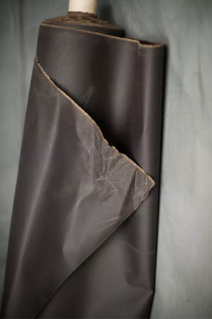 Brown oilskin fabric roll on a gray background