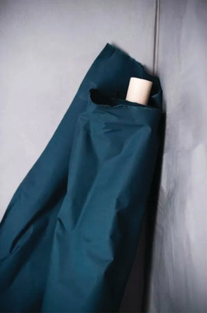 Dark Teal oilskin fabric draped over a light grey surface.