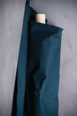 Dark Teal oilskin fabric draped over a light grey surface.