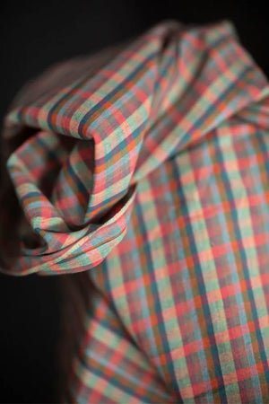 Close-up of plaid fabric with a dark background
