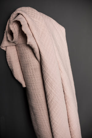 pale pink jacquard fabric with a dark grey background