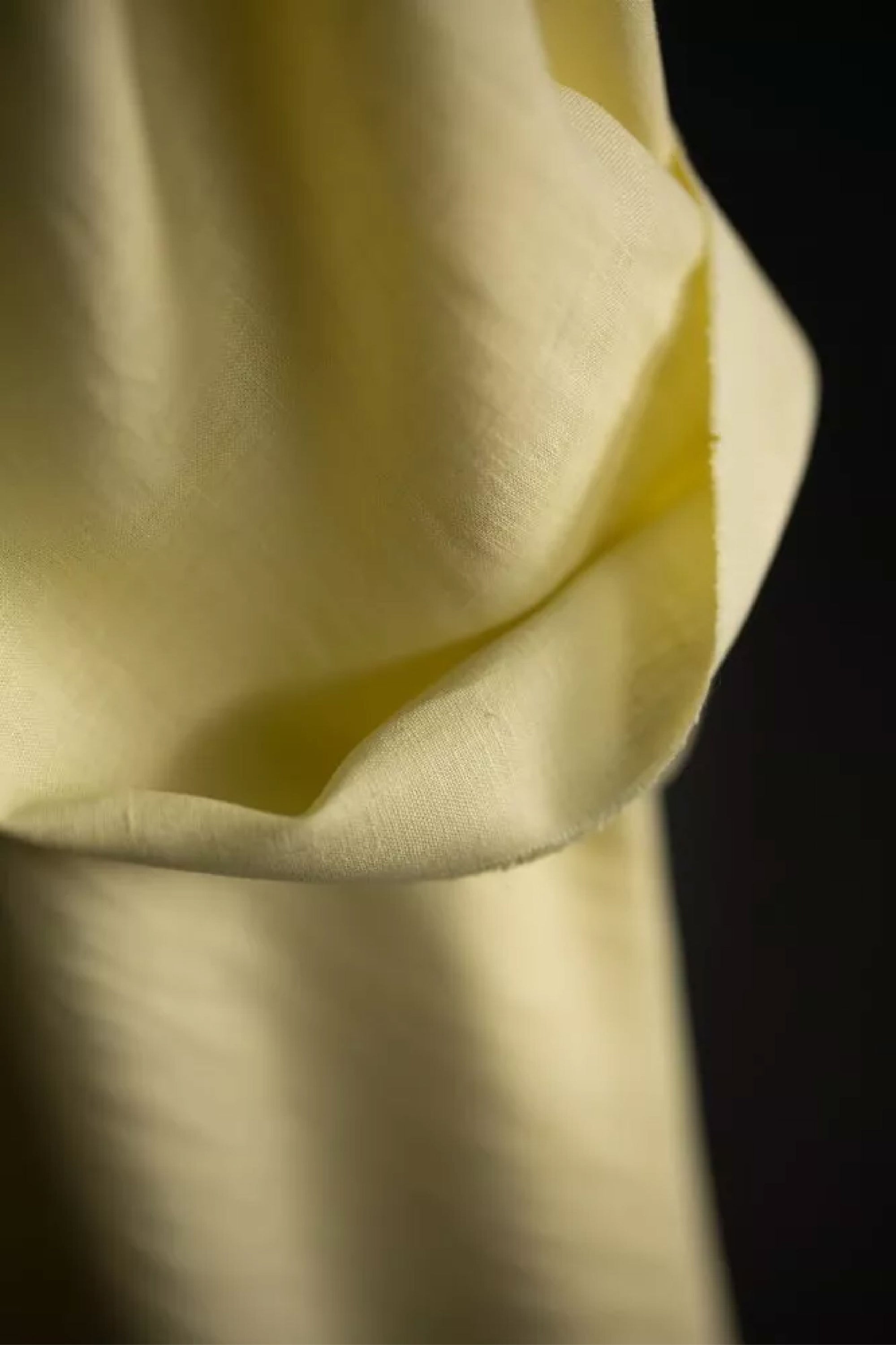 Close up of European laundered linen, tumbled at the mill for softness. Very pale yellow.