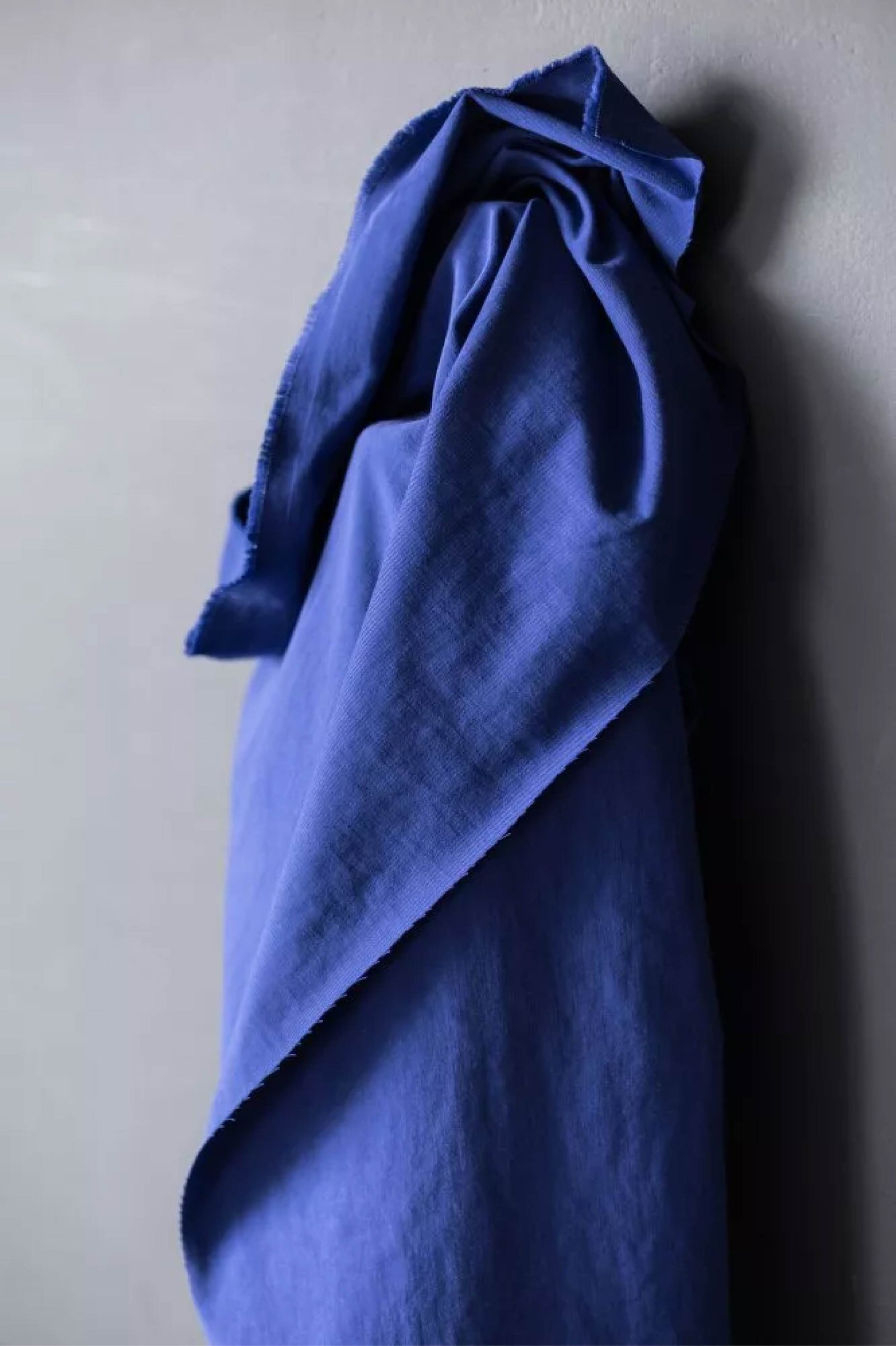 blue fabric roll by a white wall