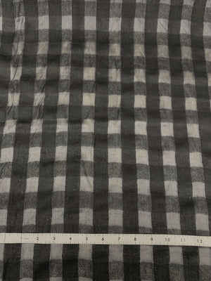 Raw silk black check transparent on alternate checks withe a measuring tape below. Checks go at one inch increments.