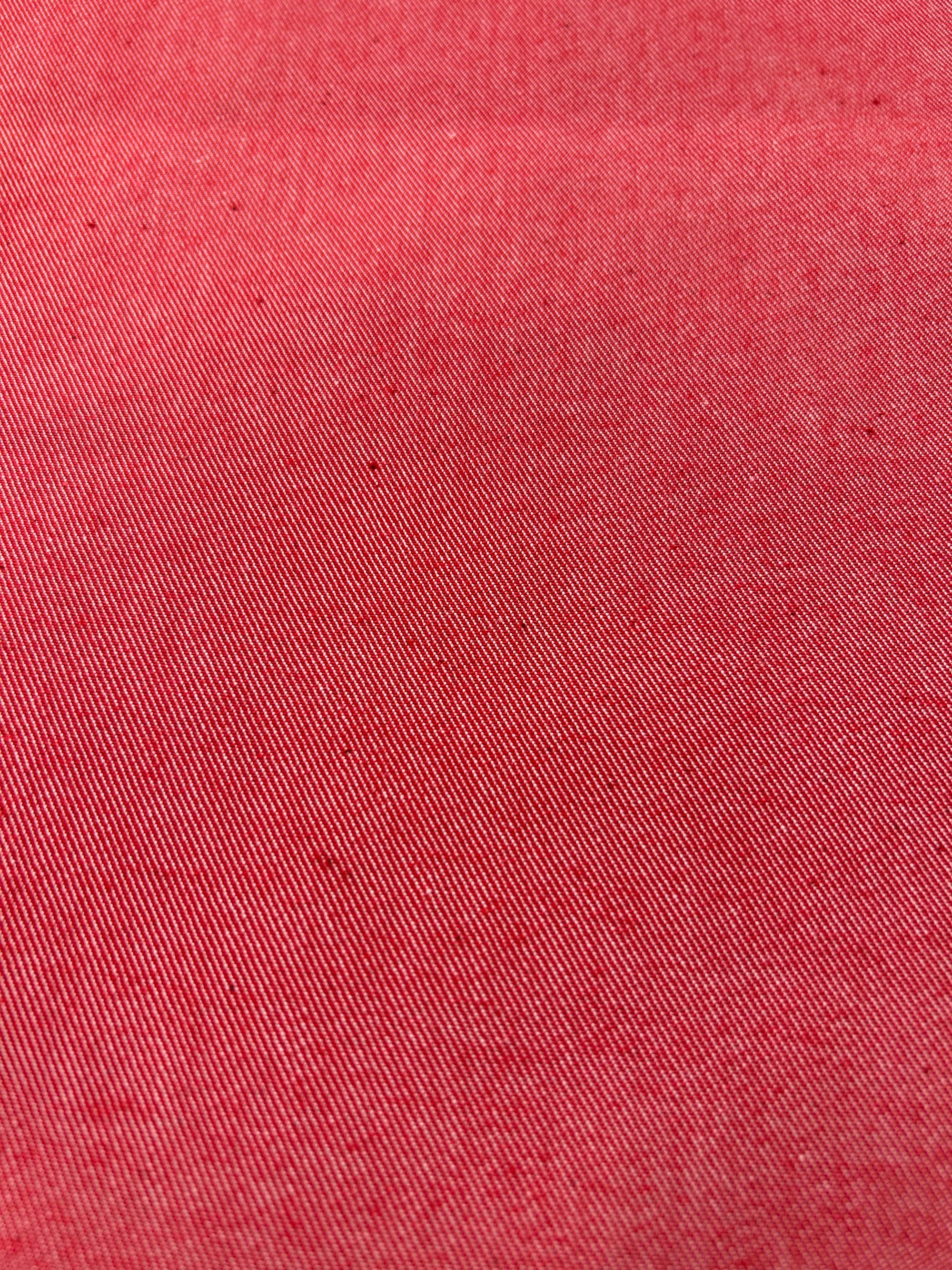 Close-up of bright red cotton denim fabric.