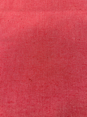Close-up of bright red cotton denim fabric.