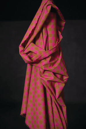 Cotton check fabric of fuchsia, mauve and ochre.
