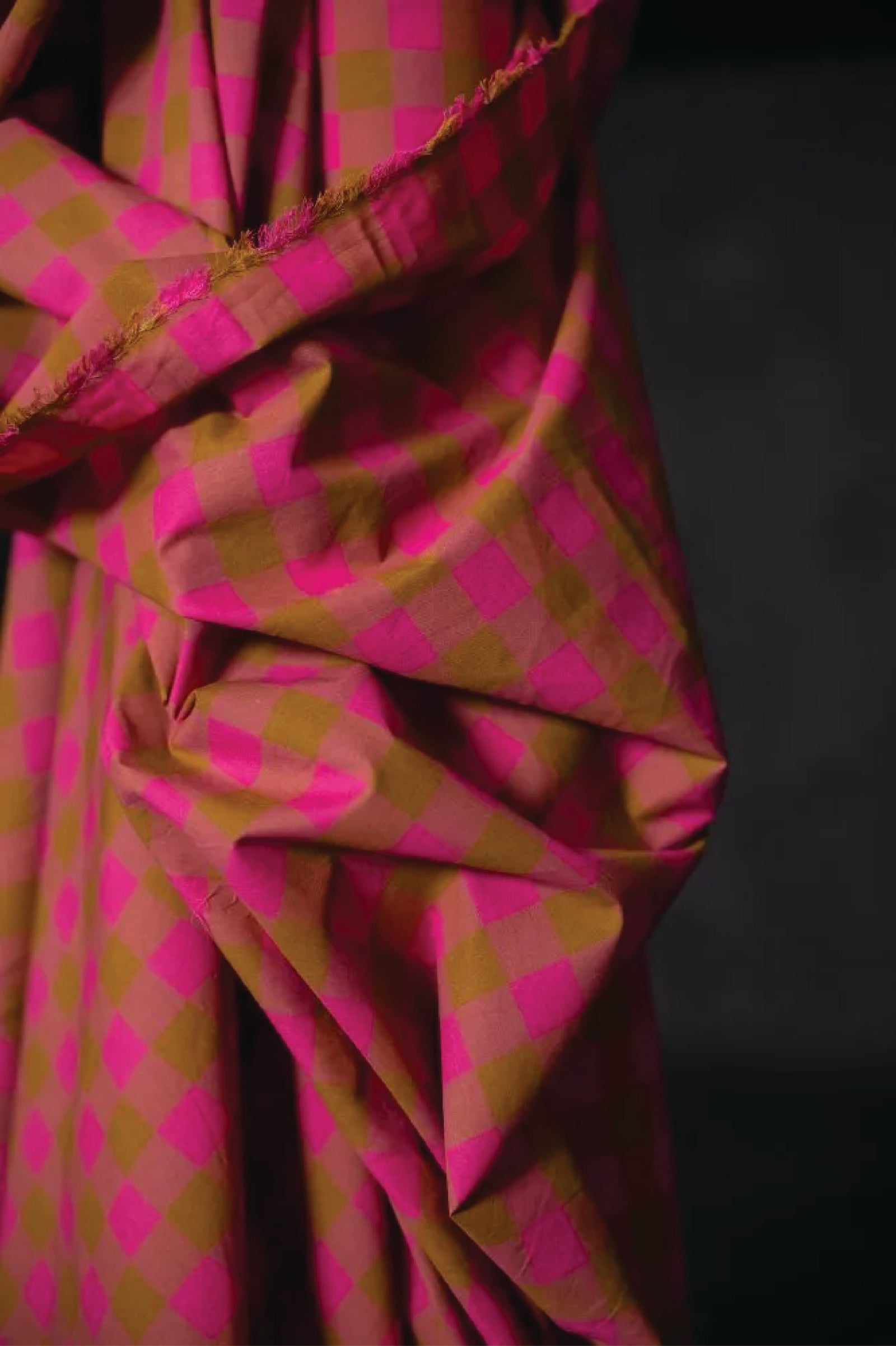 Cotton check fabric of fuchsia, mauve and ochre.