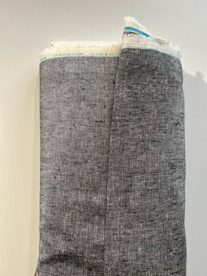 A medium-weight linen is woven with black and white threads to create the salt-and-pepper look on a fabric bolt.
