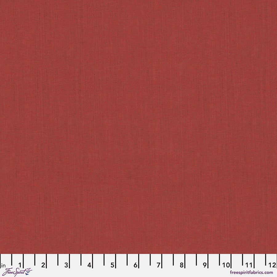 Solid rusty red fabric swatch with a ruler at the bottom