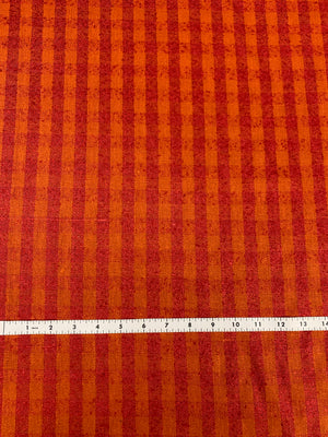 raw silk in a orange and red check with a measuring tape on the bottom. Checks are half and inch wide.