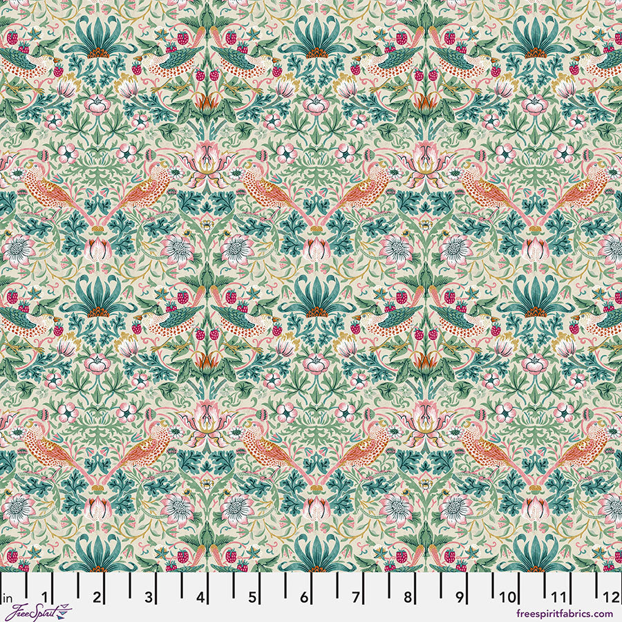 Patterned fabric with birds and flowers picking strawberries on a pink background, with green, teal, and pink foliage on a beige background. With a ruler at the bottom.