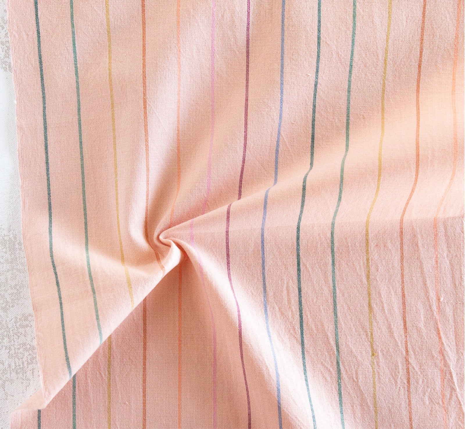 peach fabric with rainbow skinny stripes