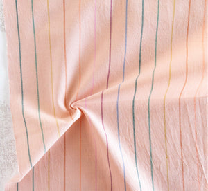 peach fabric with rainbow skinny stripes