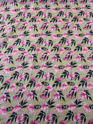 Fabric with pink and a black silhouette leaf pattern on tan background.
