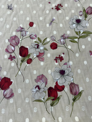 Floral pattern with red and purple tulip flowers on an ecru background with white polka dots.