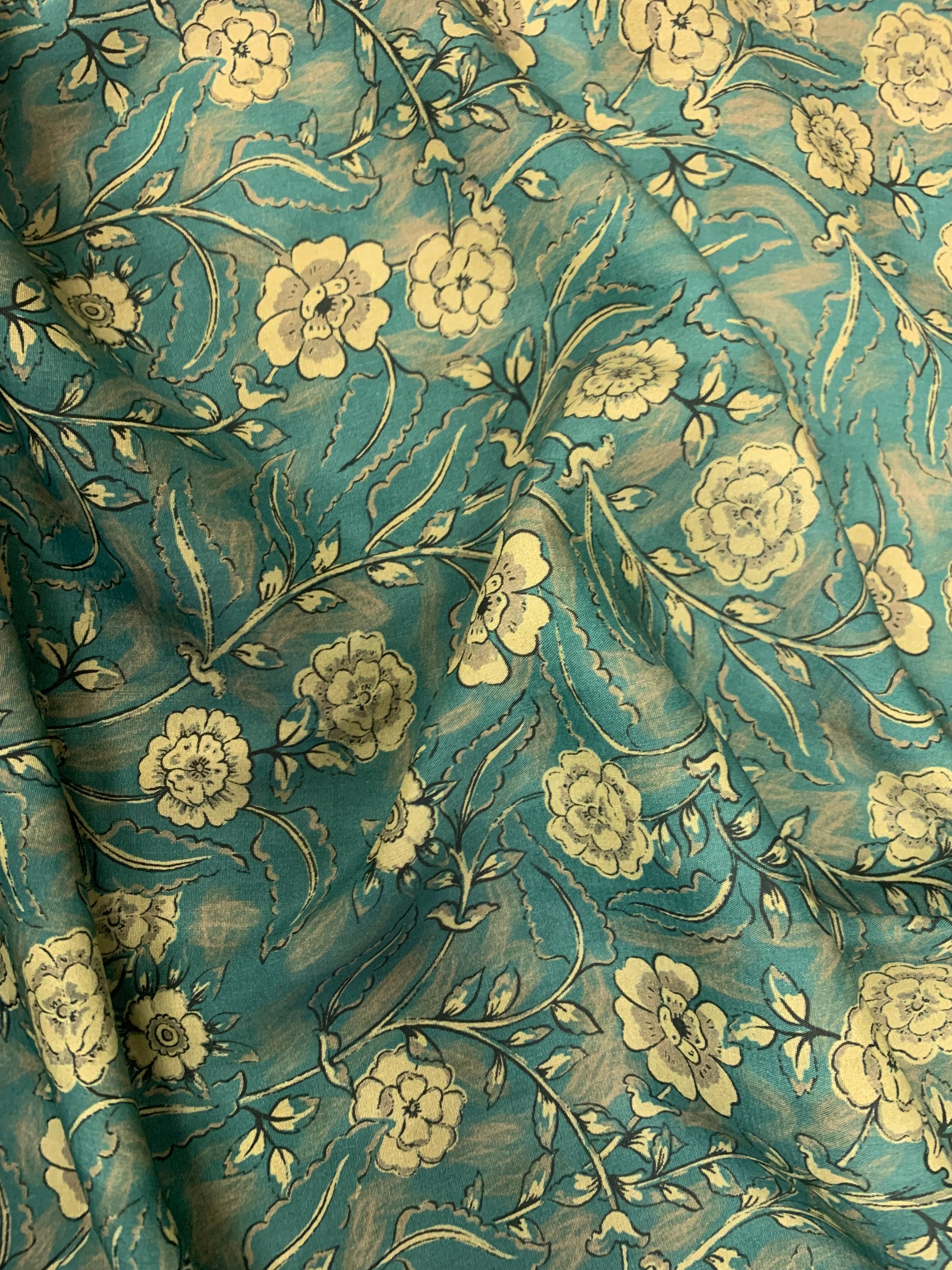 Viscose Challis Fabric is a Teal/Taupe floral print.