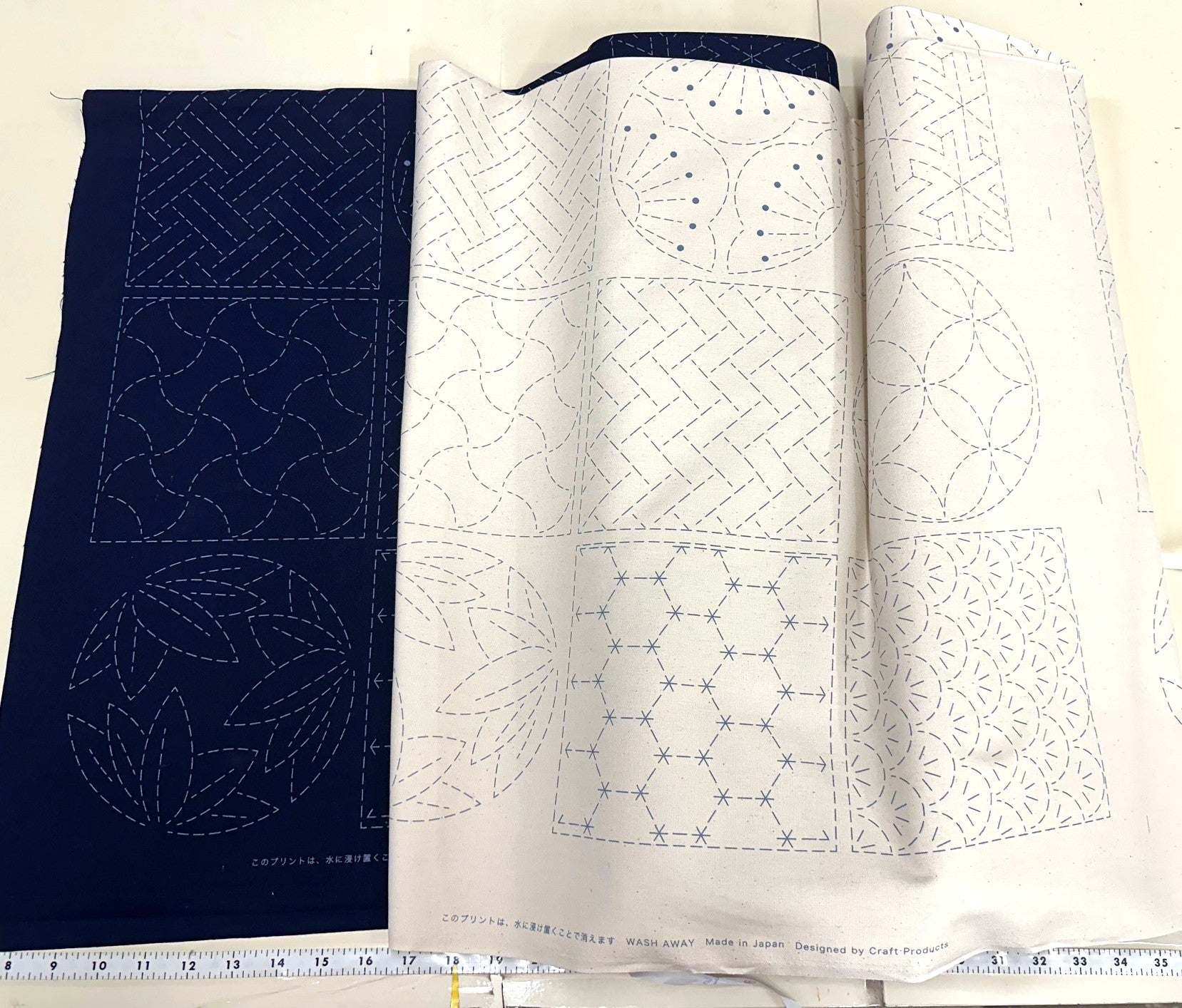 Two  pieces of sashiko fabric with different patterns on a white background.