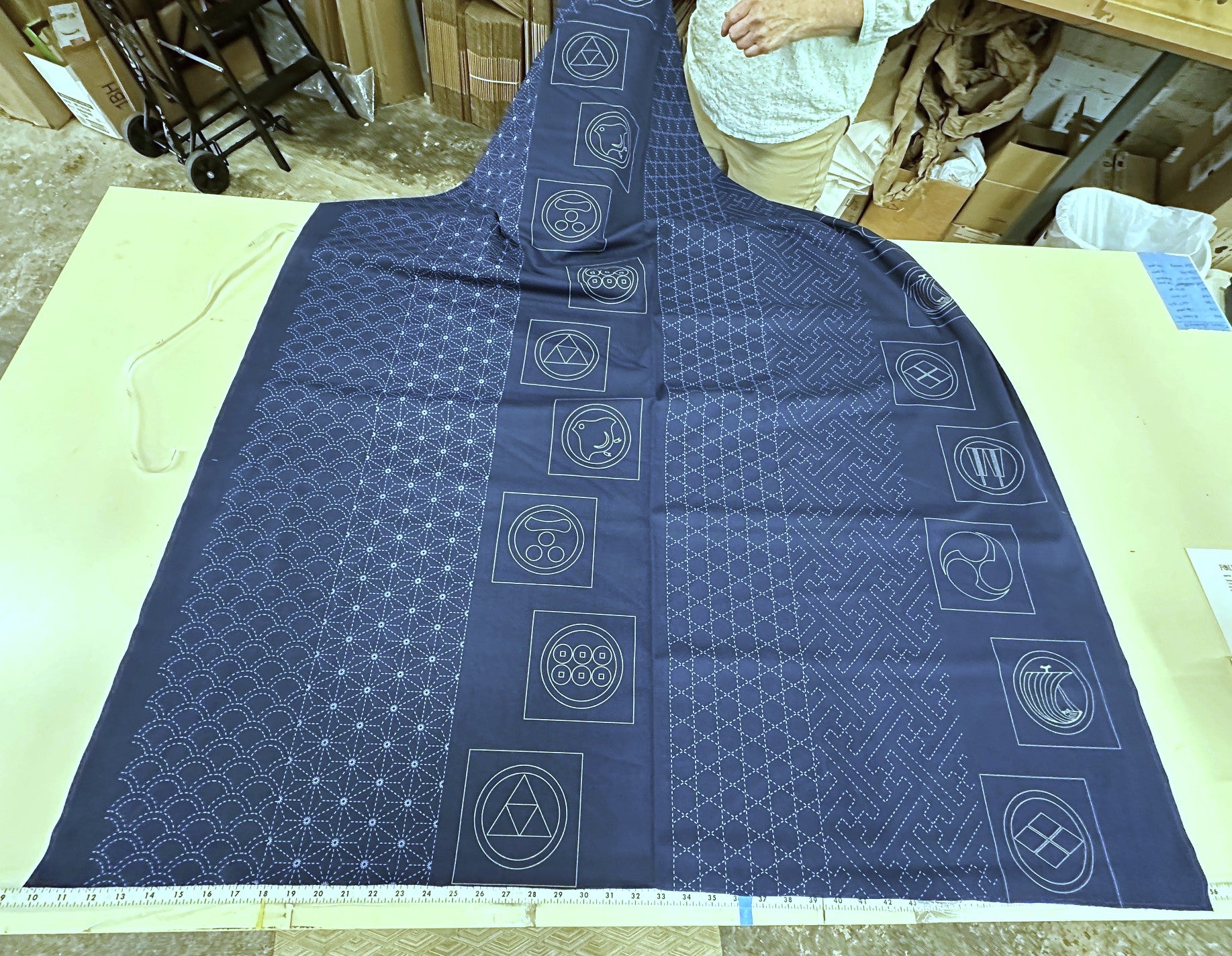 Blue fabric with geometric patterns on a light green surface