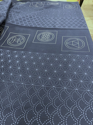 Dark blue fabric with white geometric patterns on a flat surface
