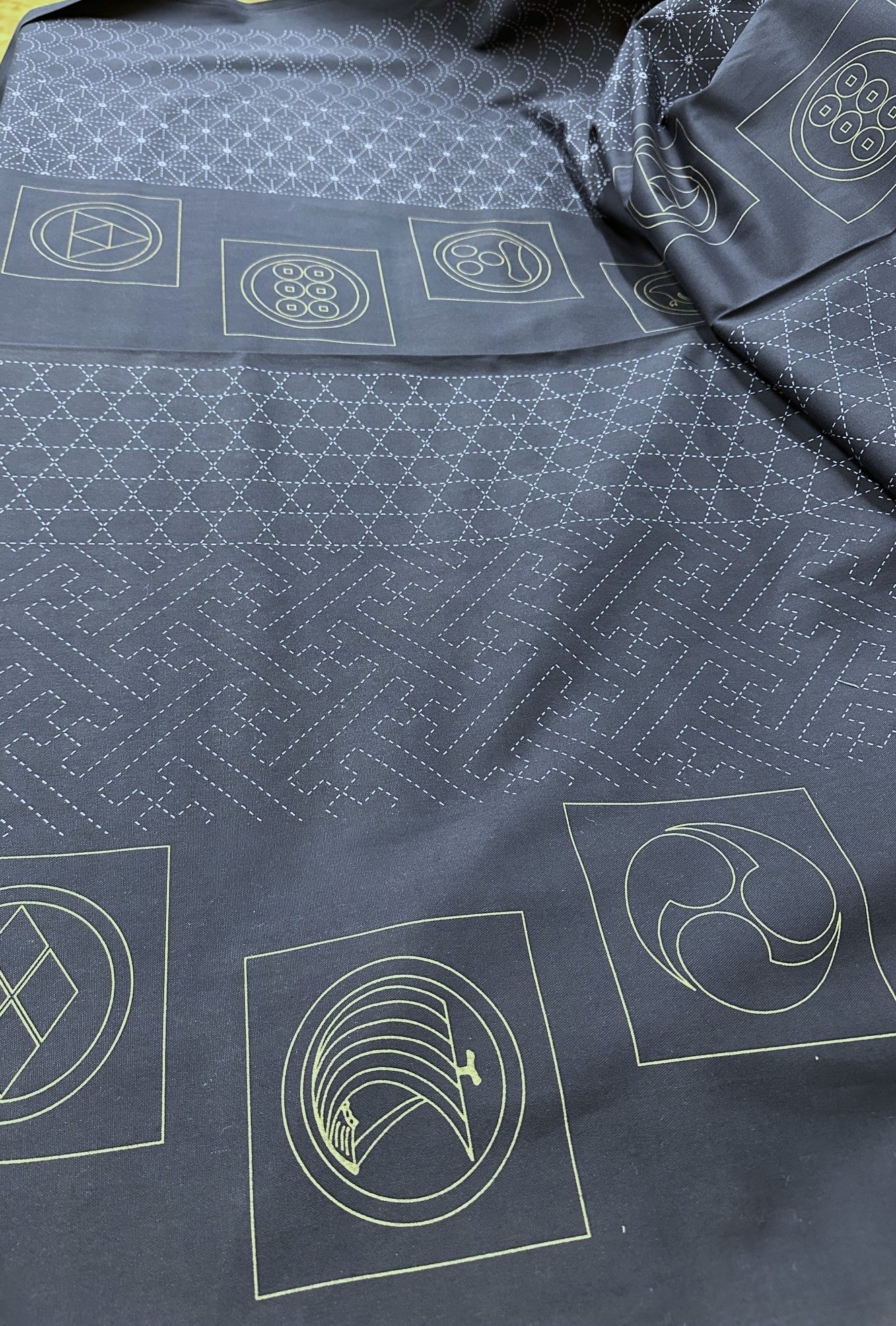 Dark fabric with white geometric sashiko patterns