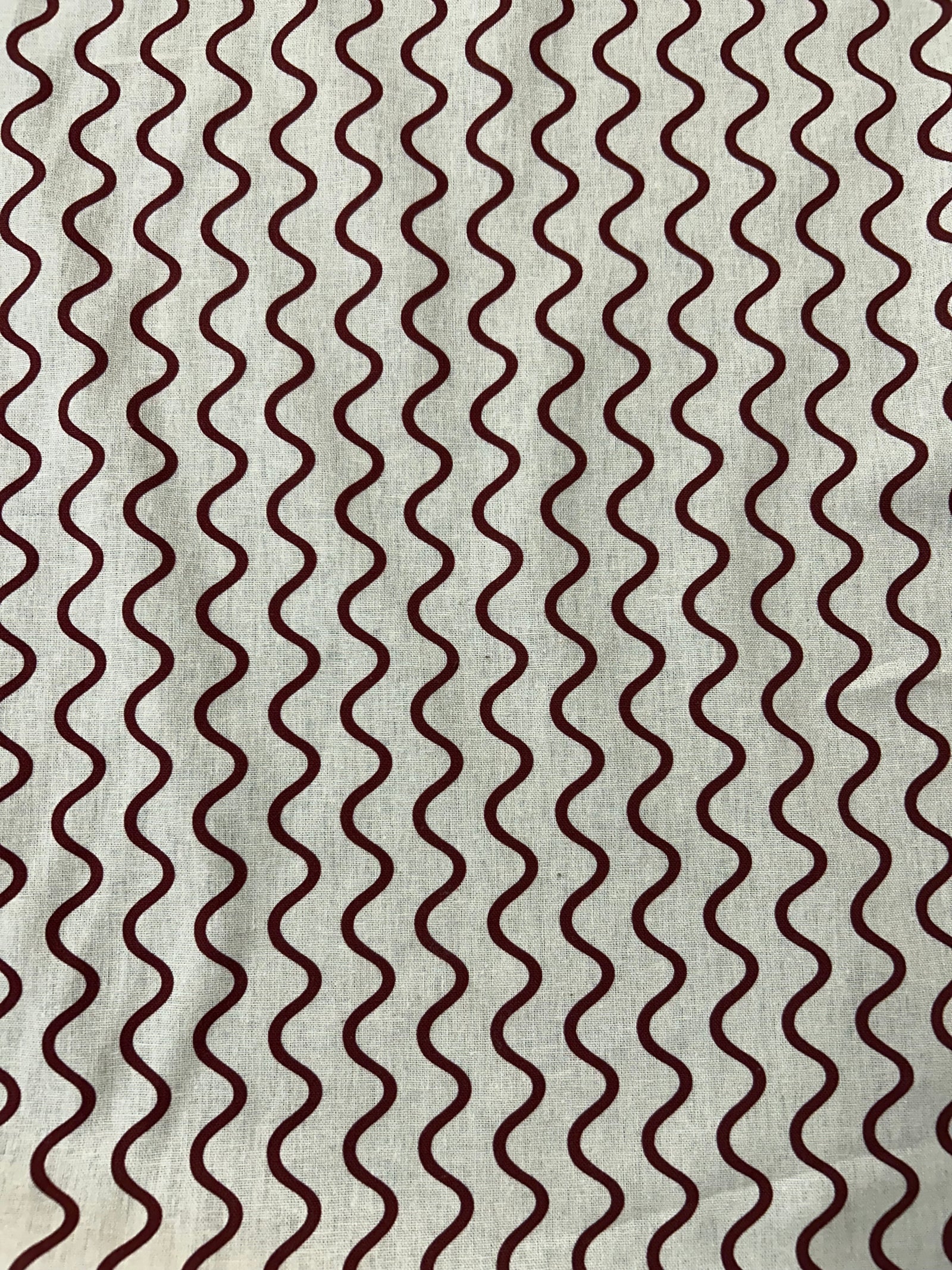 Wavy red stripe pattern on a beige background.