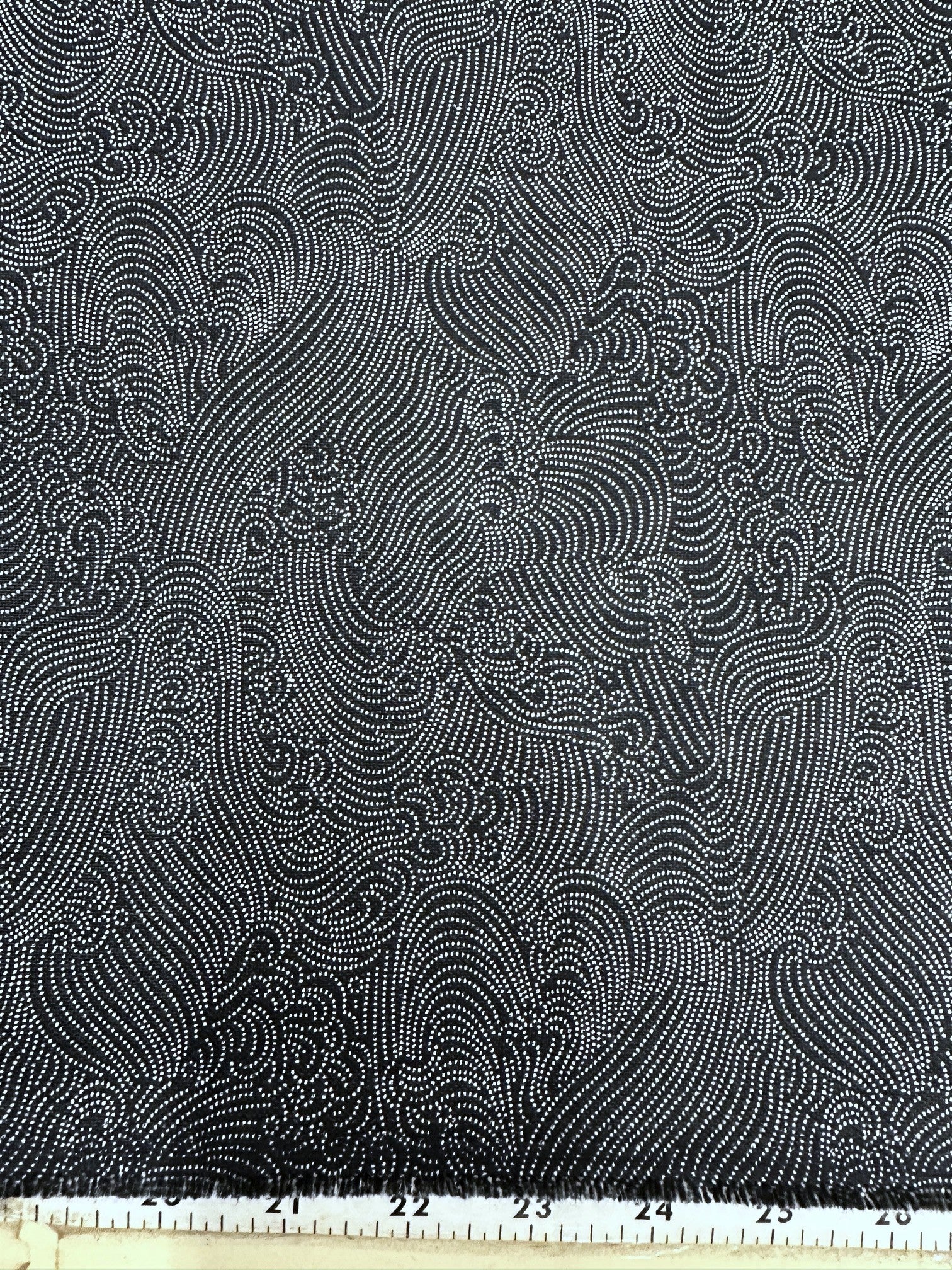 navy and white patterned fabric with a ruler at the bottom for scale.