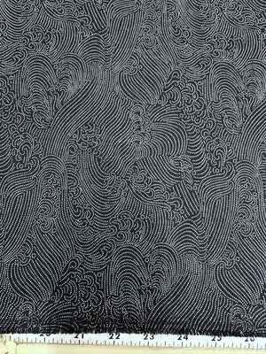 navy and white patterned fabric with a ruler at the bottom for scale.