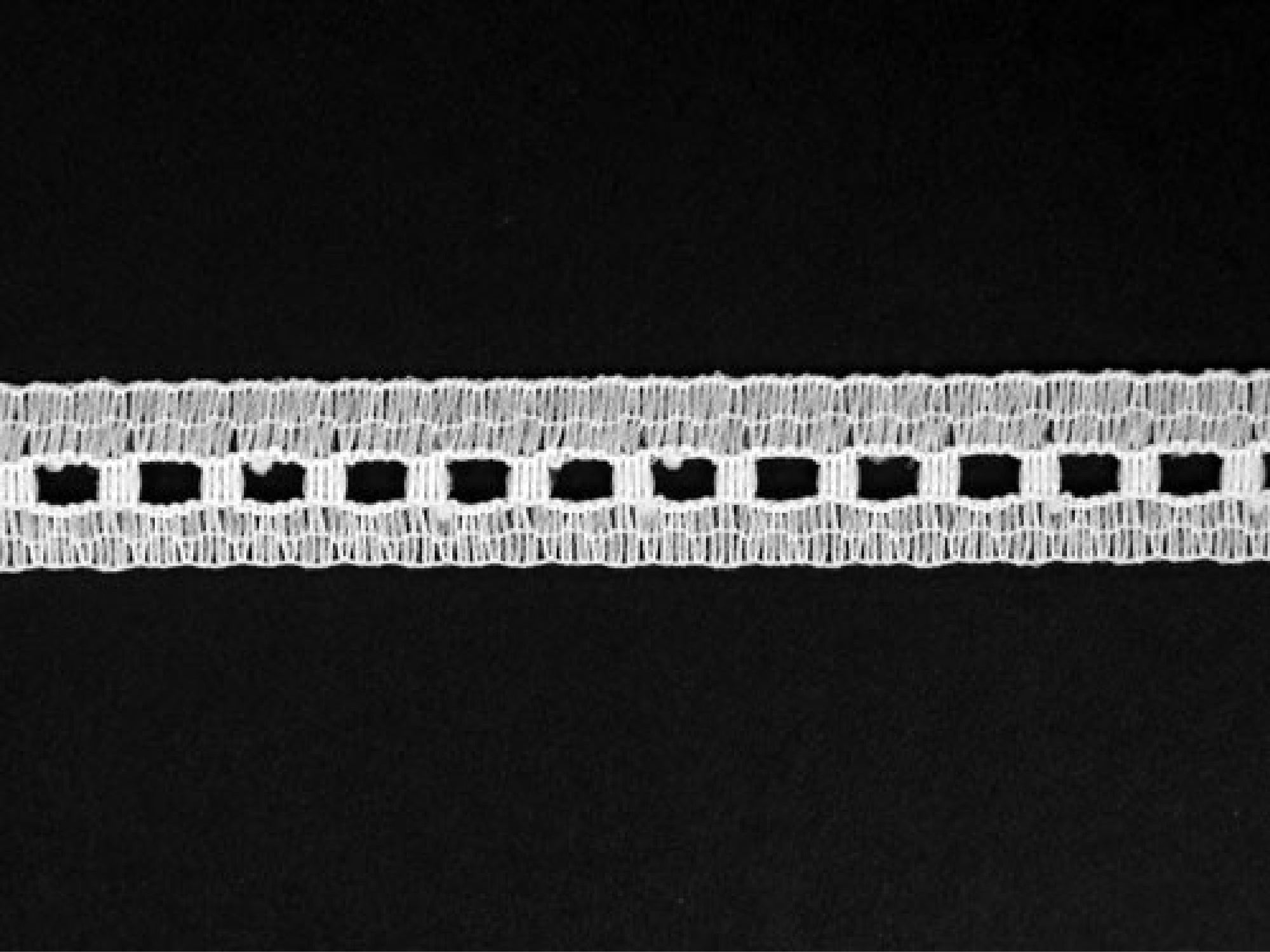 white beading lace trim on black background