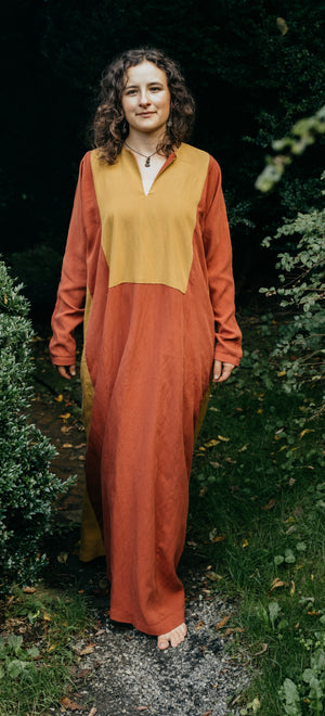 Front view of Gaza Dress, floor length red dress with large mustard yellow yoke.