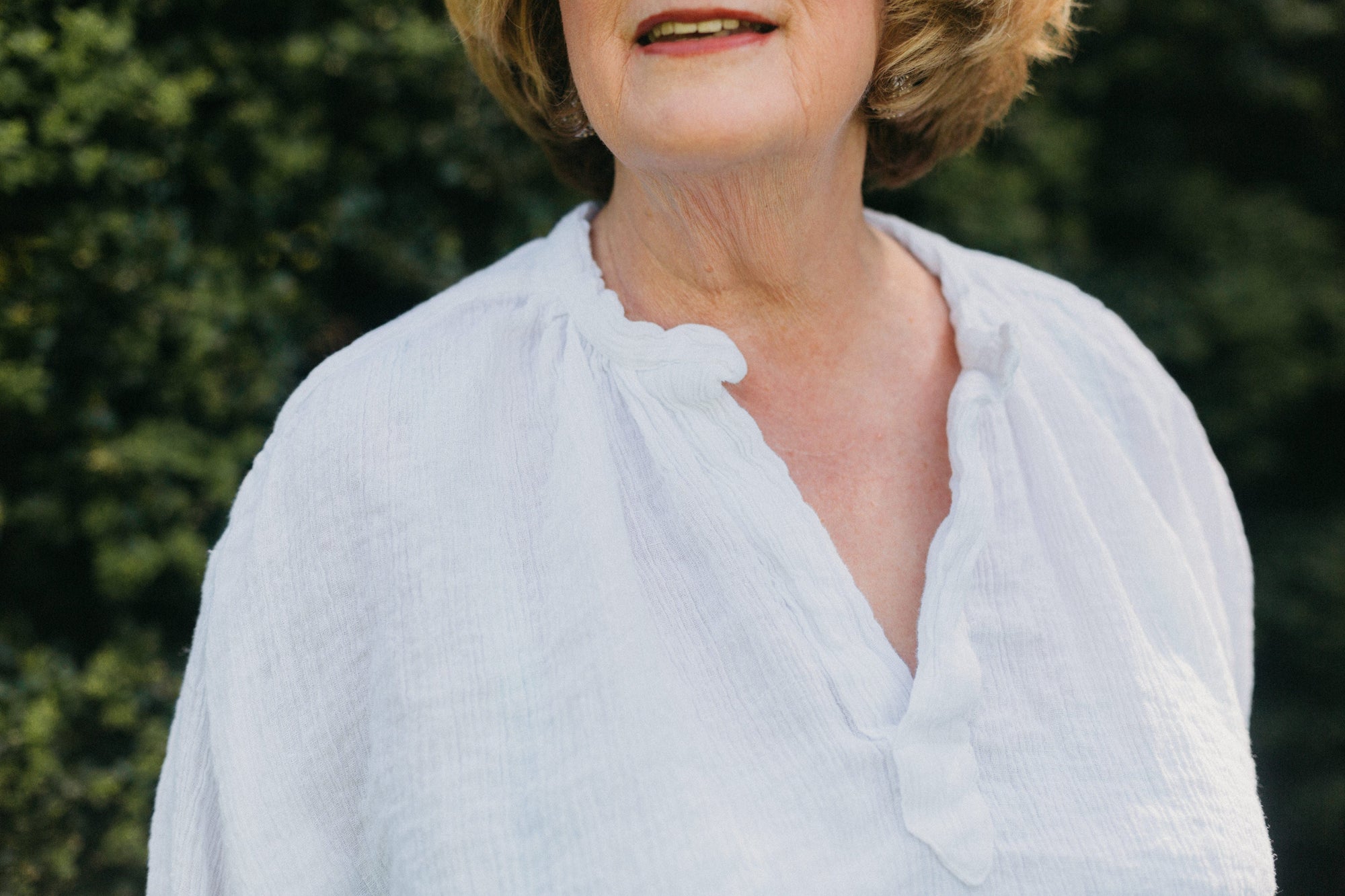 Close up of woman in French Cheesemakers Smock.  Showing the open neck placket