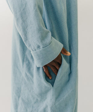 Close up of hand in the pocket of the blue dress.  Long sleeve.
