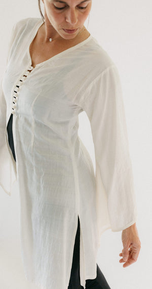 Model wearing the single layer of the Entari (tunic). Photo shows side slit and front closure/ opening.