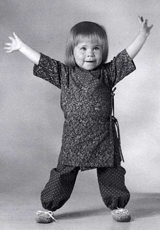 Black and white photo of toddler wearing the Nepali Chupa top and Turkish Bloomers.