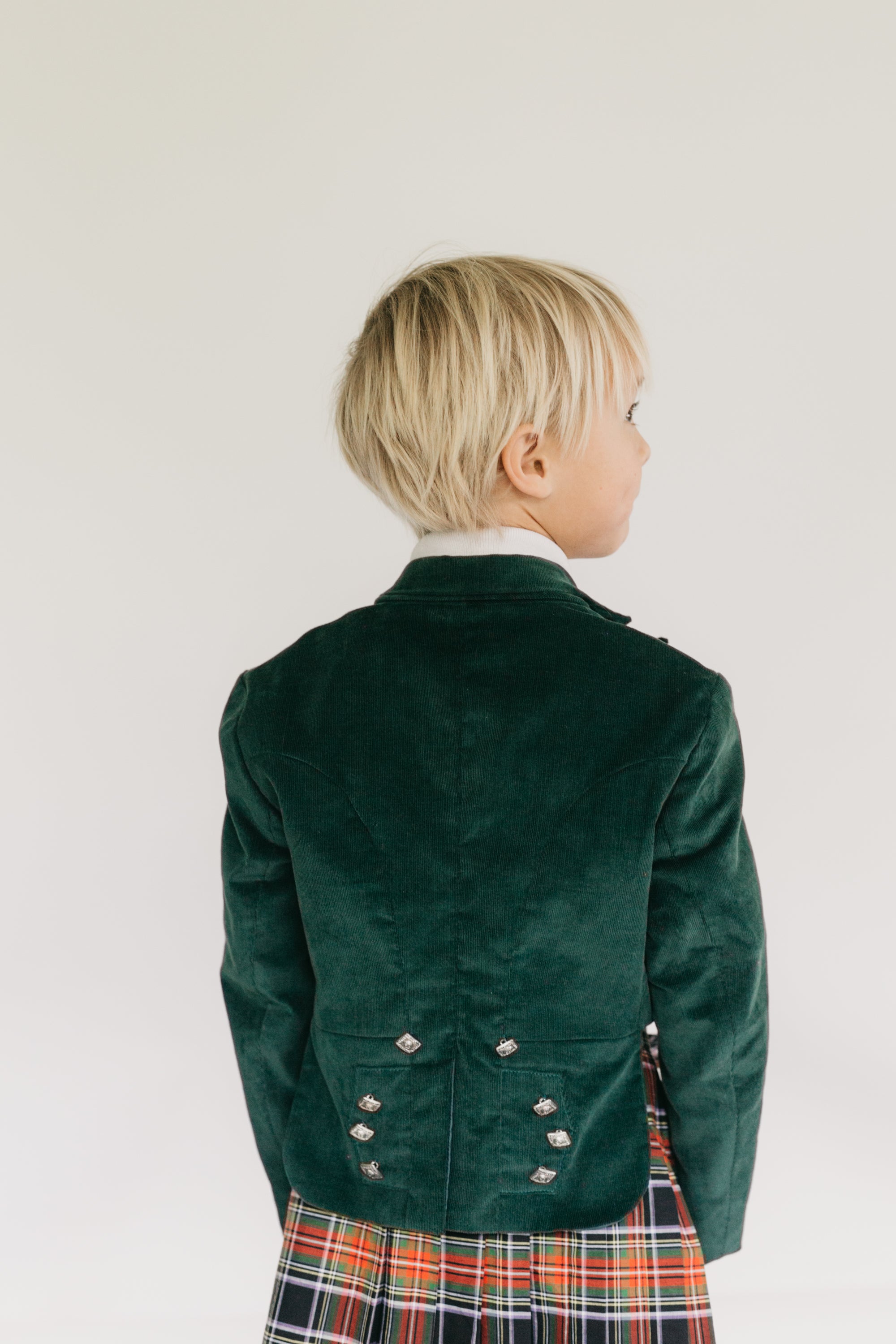 Close up photo of back of the Prince Charlie Jacket on young boy.