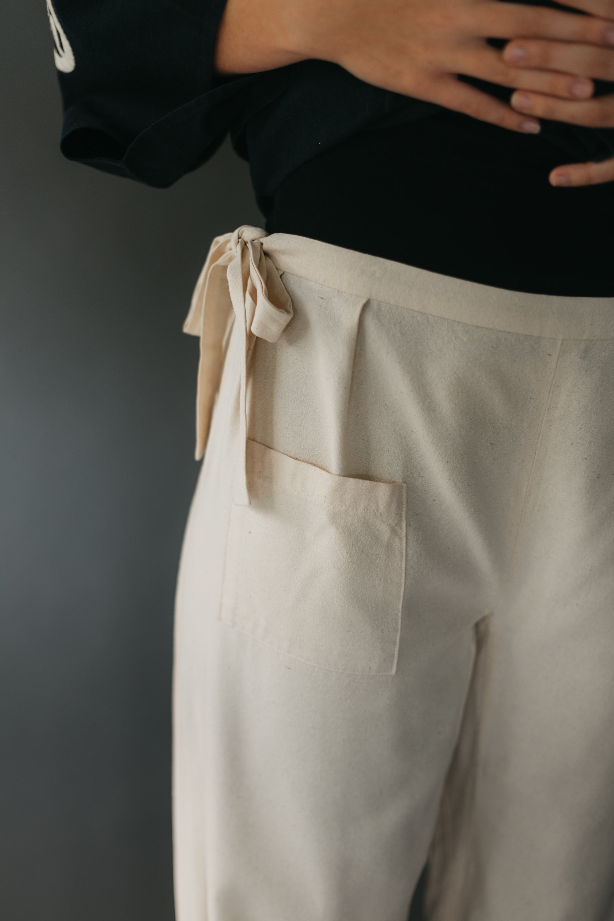 Close up of field pants pocket and ties at waist.